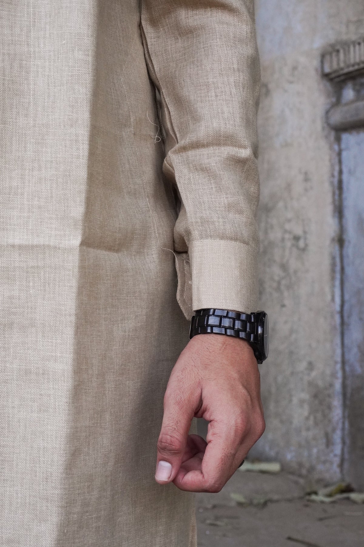 Close-up of buttoned cuff and textured fabric