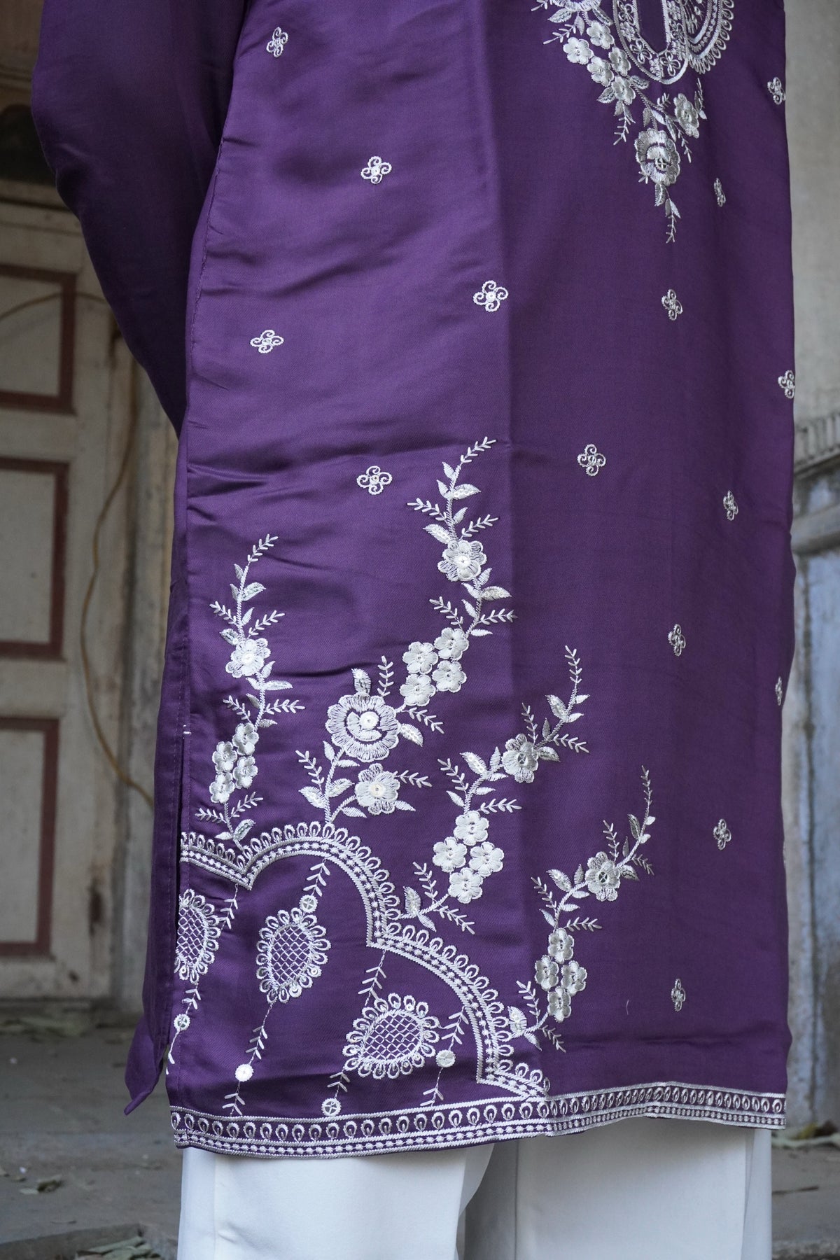 Close-up of floral vine and hem border embroidery
