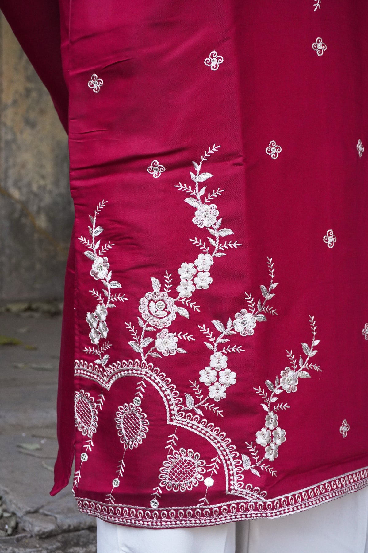 Close-up of floral vine and hem border embroidery
