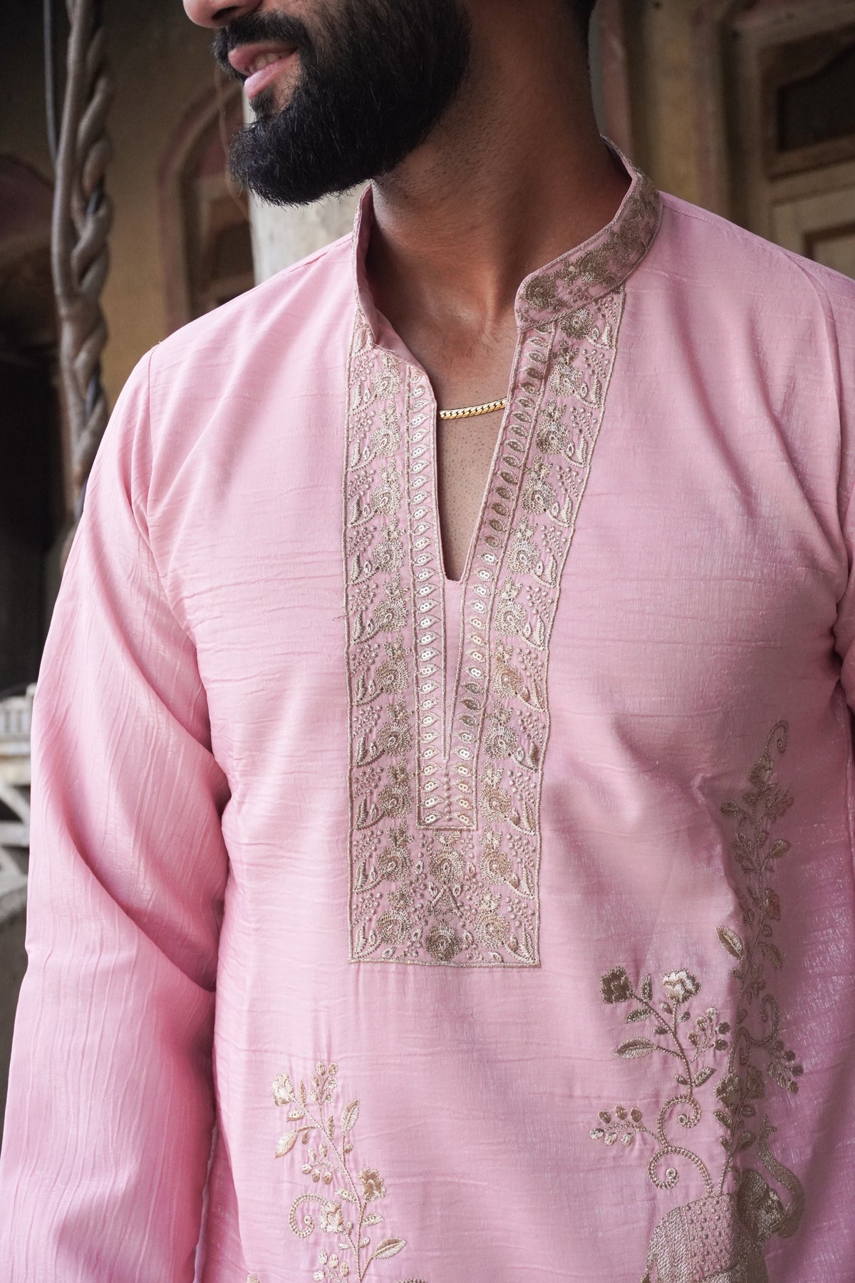 Close-up of embroidered placket and mandarin collar on pink kurta