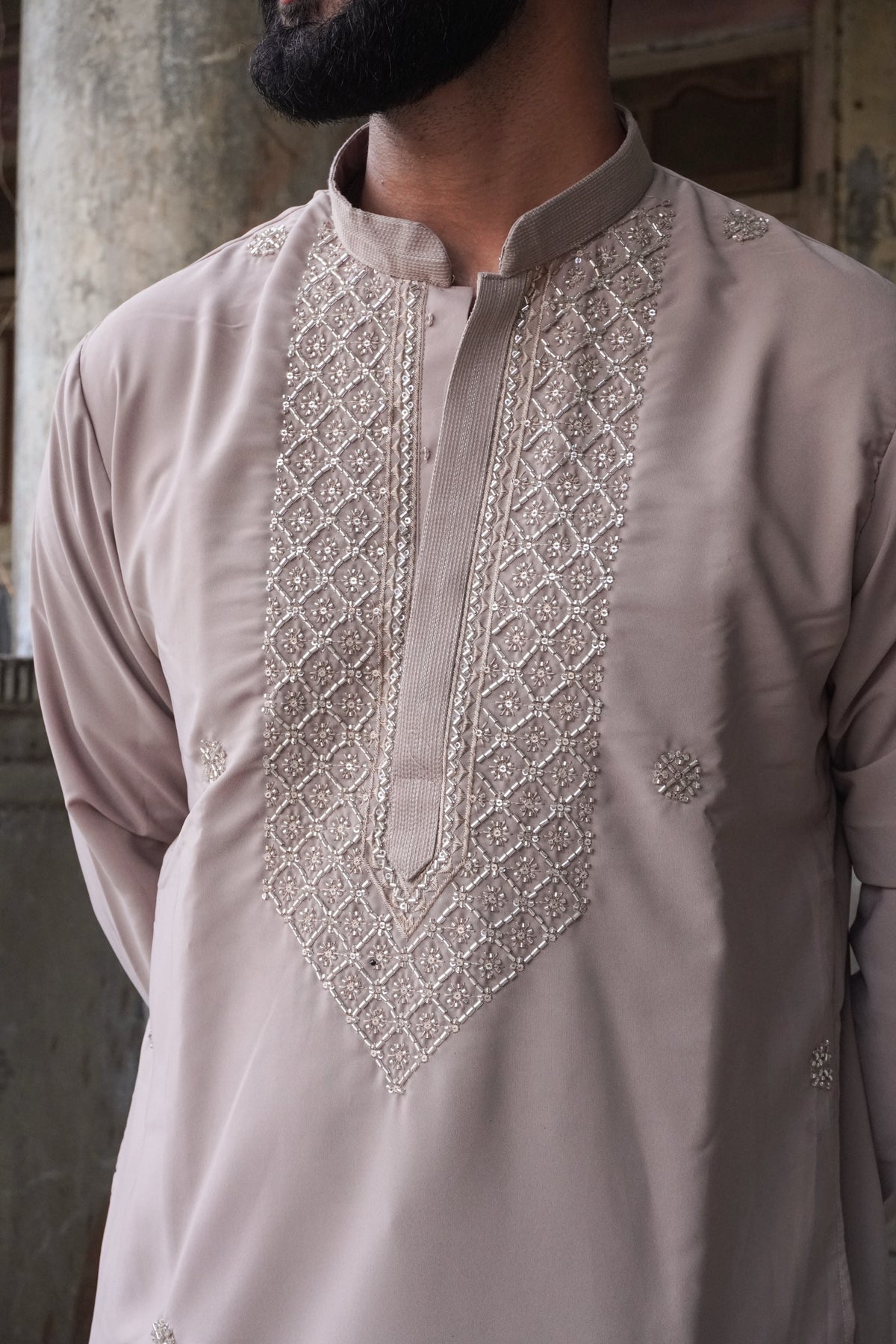 Close-up of silver bead lattice yoke and band collar