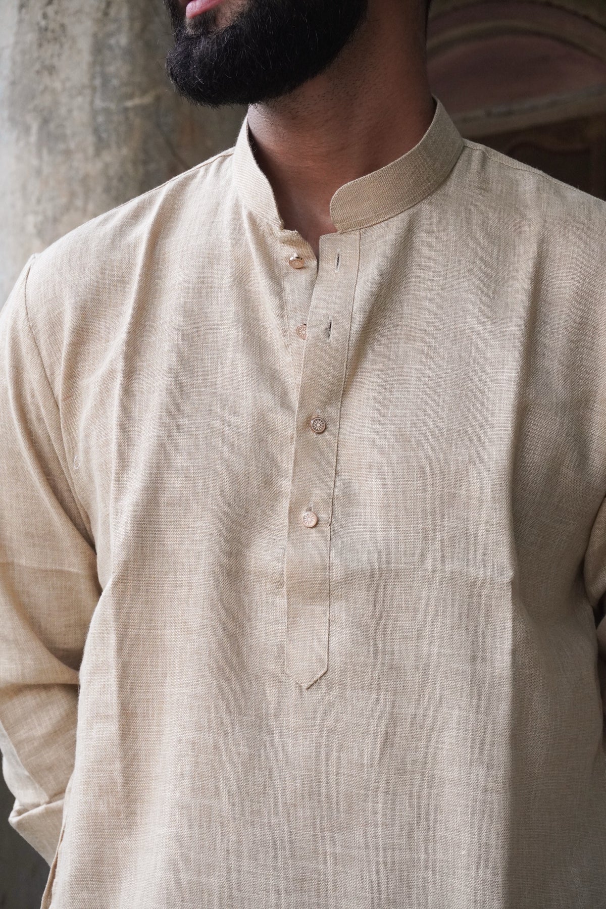 Close-up of mandarin collar and button placket on beige kurta